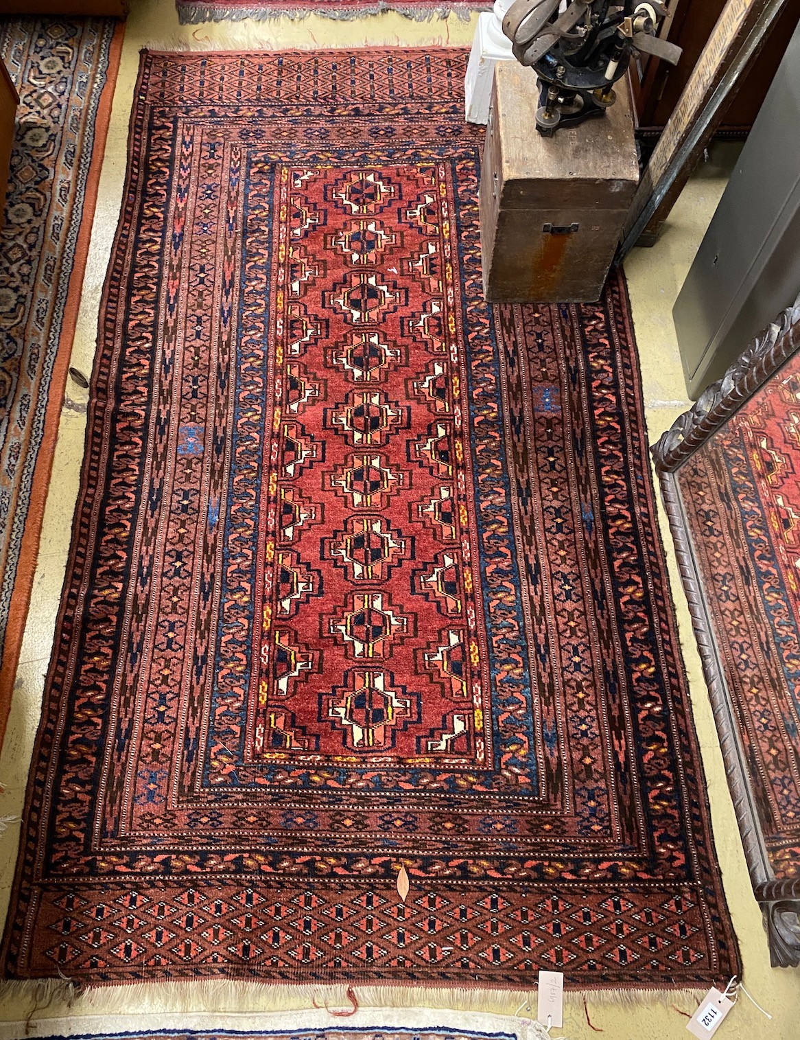 A Belouch red ground rug, 195 x 106cm